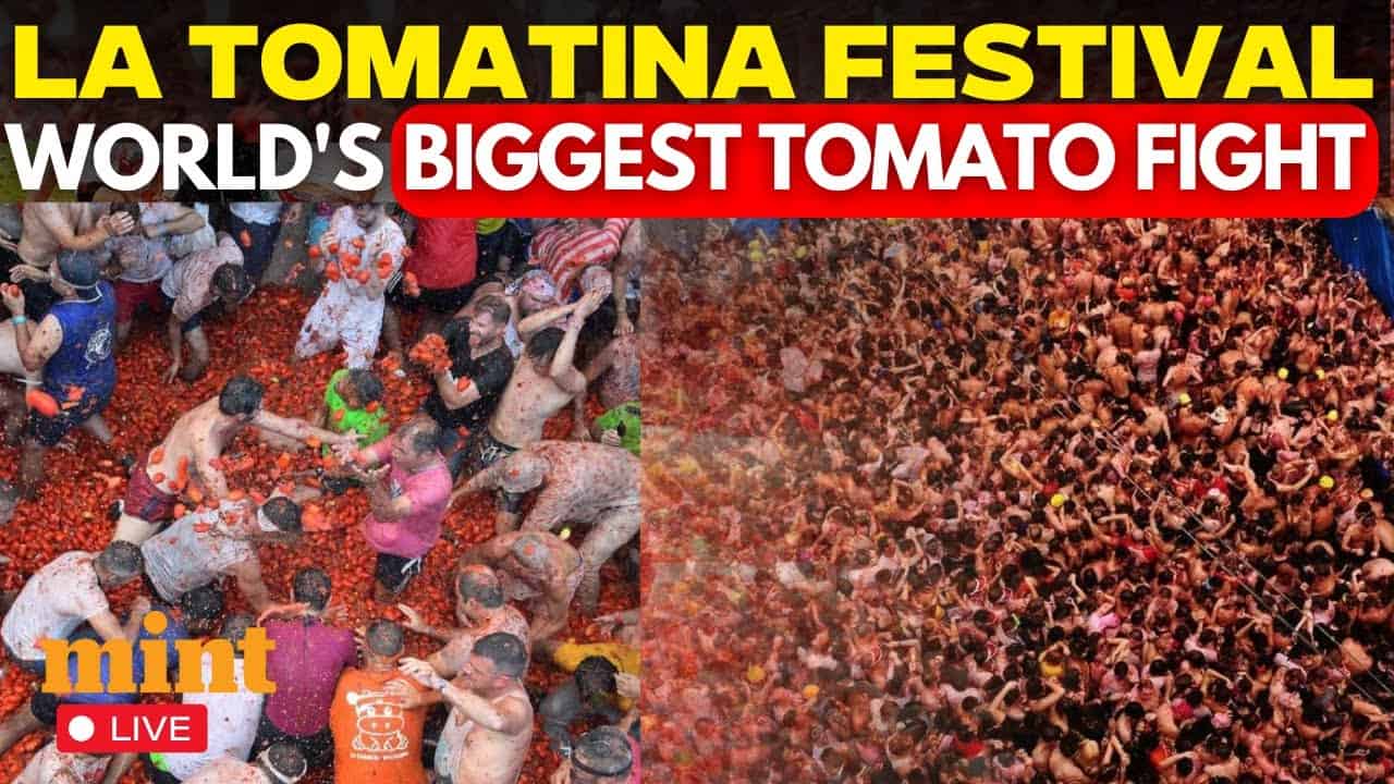 A massive truck dumping tons of overripe tomatoes into a crowded street in Valencia