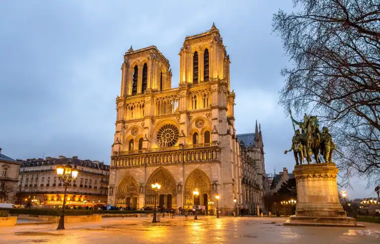 Notre-Dame Cathedral in Paris illuminated at dusk, a must-visit landmark in France.