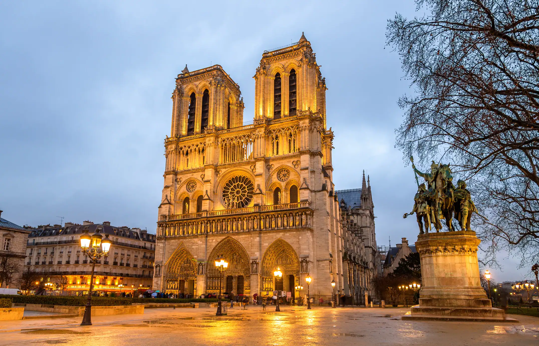 Notre-Dame Cathedral in Paris illuminated at dusk, a must-visit landmark in France.